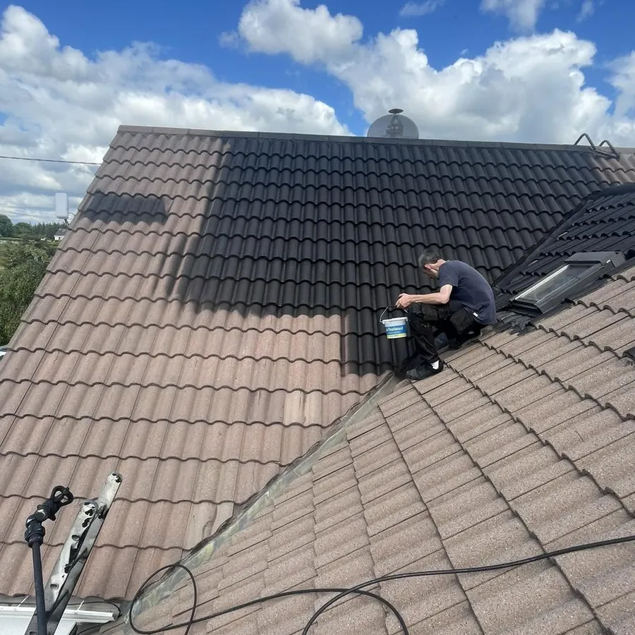 Roofer cleaning a tiled dormer bungalow roof, Flaherty Roof and Driveways